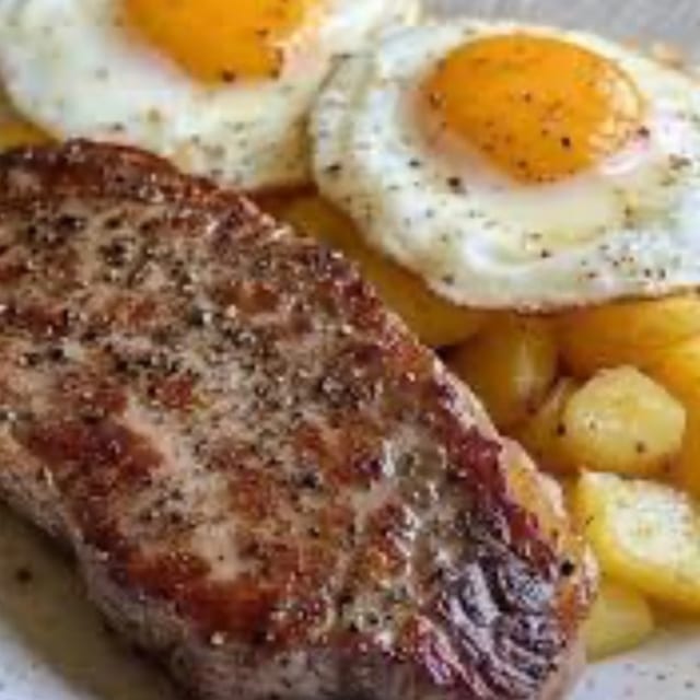 RIB EYE STEAK WITH TWO EGGS.